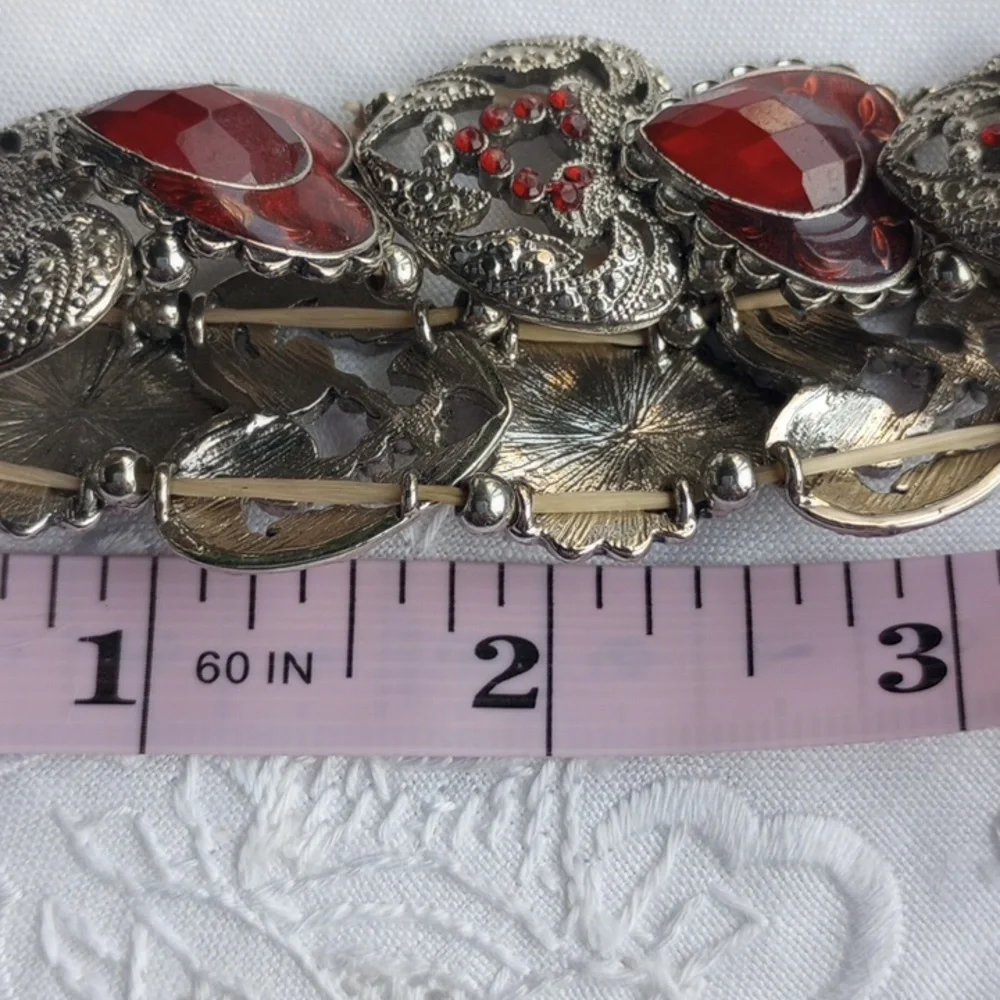 Red enamel and rhinestone encrusted silvertone heart-shaped stretchy bracelet